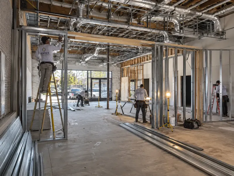 Construction crew working on framing inside a commercial building